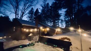 Relax in a hot tub surrounded by serene winter scenery.