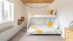 A bunk bed room with a wooden ceiling, a window, and a wall-mounted basket. - Magical Moments Hot tub & Swimmable Lake (Amherst)