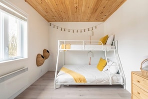 A bunk bed room with a wooden ceiling, a window, and a wall-mounted basket. - Magical Moments Hot tub & Swimmable Lake (Amherst)