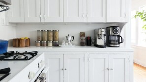 Enjoy cooking in this well-equipped kitchen with a gas stove, coffee maker, and kettle.