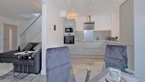 A modern kitchen with a built-in oven and a stainless steel range hood. - Contemporary HIGHLAND HOUSE close to town and Ben Nevis (Fort William)