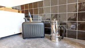A kitchen counter with a toaster, a coffee maker, and a knife block. - The Yellow Nest, Studio at Victoire Square (Burdeos)
