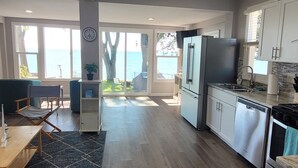 A spacious kitchen with a view of the sea, modern appliances, and a dining area with a view.