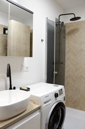 Shower, hair dryer, towels, soap