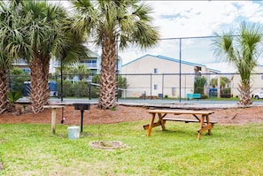 Enjoy a peaceful outdoor space surrounded by palm trees, complete with a picnic table and bird feeder.