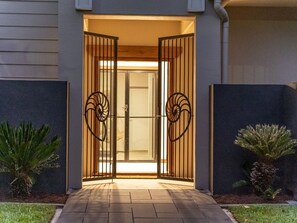 Enter through the distinctive spiral metal gate to a well-lit interior.