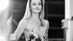 A person in a dress with a floral pattern.