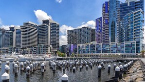 A marina with boats docked, surrounded by modern high-rise buildings. - KOZYGURU | DOCKLANDS | HIGH LEVEL WATERVIEW | 1BED  |  POOL  | VDO883 (Docklands)