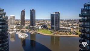 A high-rise building complex with a marina in the foreground. - KOZYGURU | DOCKLANDS | HIGH LEVEL WATERVIEW | 1BED  |  POOL  | VDO883 (Docklands)