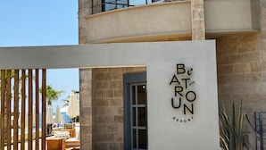 A multi-story building with a sign reading 'Be Aro Un Resort.' - Bebatroun Beach Hotel (Batroun)