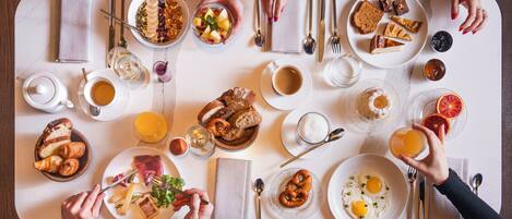 A breakfast setting with various dishes, utensils, and a table.