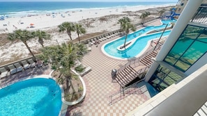 A resort with a pool area, beach view, and a lifeguard tower. - 3rd Floor!! New Owner, New to the Rental Market, Lazy River and Slide!! (Orange Beach)