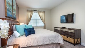 A bedroom with a bed, a dresser, a television, and a window with curtains. - Amazing Villa on Champions Gate Resort With the Best 5 Star Amenities, Orlando Villa 2846 (Davenport)
