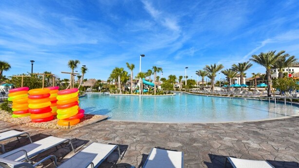 A pool area with lounge chairs and a water slide. - 5 Star Villa Close to Disney, Orlando Villa 1761 (Davenport)