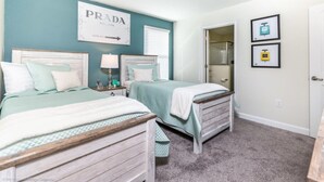 A bedroom with two beds, a window with blinds, a door, and a wall with a Prada sign. - Luxury Holiday Mansion Minutes From Disney on Champions Gate Resort, Orlando Mansion 2596 (Davenport)