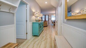 A hallway with a light blue door, a teal cabinet, and a mirror on the wall. - 5 Star Villa on Champions Gate Resort With First Class Amenities, Orlando Villa 2533 (Davenport)