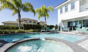 A swimming pool with a hot tub, surrounded by palm trees and lounge chairs. - 5 Star Villa on Orlandos Most Exclusive Reunion Resort and Spa, Orlando Villa 4598 (Kissimmee)