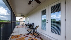 A covered porch with a ceiling fan, a table with chairs, and a decorative rug. - 5 Star Villa on West Haven With First Class Amenities, Orlando Villa 1825 (Davenport)