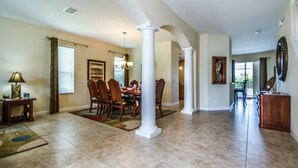 A spacious dining area with a high ceiling, large windows, and a view of the outdoors. - 5 Star Villa on West Haven With First Class Amenities, Orlando Villa 1825 (Davenport)