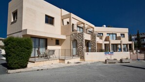 A modern building with a flat facade, multiple balconies, and a 'No Parking' sign. - Beautiful Apartment With Communal Pool, Ayia Napa Apartment 1282 (Ayia Napa)