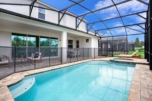 A modern house with a swimming pool, covered patio, and large windows. - Beautiful Mansion With Private Pool, Close to Disney, Orlando Mansion 3113 (Kissimmee)