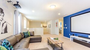 A living room with a sectional sofa, a coffee table, and a TV screen. - Modern Oasis With 7 Bedrooms & Garden 5524 (Kissimmee)