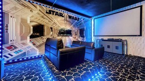 A Star Wars-themed room with a control panel, seating area, and a large screen. - Exclusive 5 Star Villa With Private Pool on Windsor Hills Resort, Orlando Villa 4914 (Kissimmee)