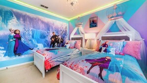A bedroom with a winter-themed mural, a canopy bed, and a nightstand with a lamp. - Exclusive 5 Star Villa With Private Pool on Windsor Hills Resort, Orlando Villa 4914 (Kissimmee)