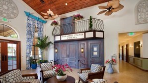 A lobby with a seating area, a balcony with a sign reading "Paradise Palms Cinema", and a ceiling fan. - Imagine You and Your Family Renting This 5 Star Villa on Paradise Palms Resort , Orlando Townhome 5537 (Kissimmee)