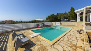 A rooftop swimming pool with stone flooring, a white fence, and a view of the sea. - Imagine Your Family Renting This Luxury Contemporary Style Villa in Ayia Napa, Ayia Napa Villa 1371 (Ayia Napa)