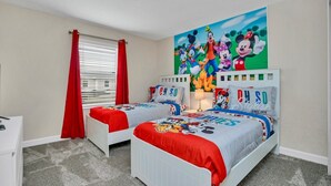 A bedroom with two beds, red curtains, a large Disney-themed wall mural, and a white dresser. - Imagine You and Your Family Renting This 5 Star Villa on Storey Lake Resort , Orlando Townhome 5519 (Kissimmee)