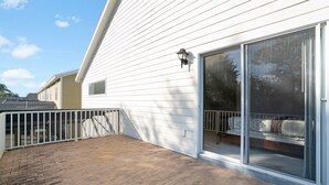 A house with a covered patio, a sliding glass door, and a small window. - Imagine You and Your Family Renting This 5 Star Villa on Providence Resort, Orlando Villa 3629 (Davenport)