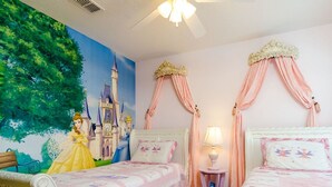 A children's bedroom with two beds, a mural of a castle, and a nightstand with a lamp. - Luxury 6 Bedroom Villa on Emerald Island Resort, Orlando Villa 1460 (Kissimmee)