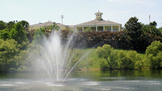 A fountain in a park with a building in the background. - Luxury Home on Bahama Bay Resort,minutes From Disney World, Orlando Condo 5057 (Davenport)
