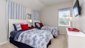 A bedroom with two beds, a TV, a window with blinds, and a small desk with a lamp. - Luxury 5 Bed Villa, Perfect for Large Groups, 1005 (Davenport)