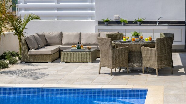 A poolside area with a pool, a sofa set, and a dining table with chairs. - Luxury Modern 3 Bed Villas Near the Beach, Protaras Villa 1077 (Paralimni)