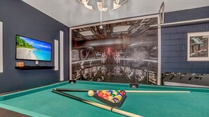 A pool table with a Star Wars-themed mural, a television, and a billiards rack. - Enjoy a Holiday of a Lifetime in a Luxury Villa on Windsor at Westside Resort, Orlando Villa 5051 (Kissimmee)