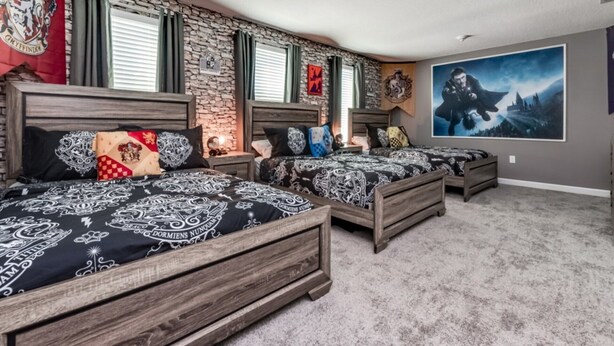 A bedroom with three wooden beds, a stone wall, and a large poster of a wizard on the wall. - Rent a Luxury Mansion on Storey Lake Resort, Minutes From Disney, Orlando Mansion 3232 (Kissimmee)