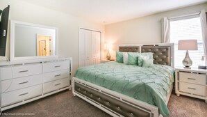 A bedroom with a bed, dresser, mirror, and bedside lamps. - Picture Renting Your Own Luxury Mansion on the Exclusive Champions Gate Resort, Close to Disney, Orlando Mansion 2599 (Davenport)