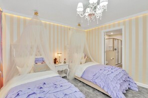 A bedroom with two beds, a canopy bed, a chandelier, and a walk-in closet. - At Last You can Rent the Perfect Luxury Mansion on Storey Lake Resort, Minutes From Disney World, Orlando Mansion 5040 (Kissimmee)