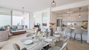 A modern apartment with a dining area, kitchen, and living space. - Your Beautiful Holiday Villa in Protaras and Close to the Beach, Protaras Villa 1567 (Paralimni)