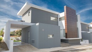 A modern two-story house with a flat roof, large windows, and a minimalist design. - Your Beautiful Holiday Villa in Protaras and Close to the Beach, Protaras Villa 1567 (Paralimni)