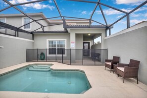 An outdoor swimming pool area with a covered patio, a fenced enclosure, and outdoor furniture. - You Have Found the Perfect Holiday Villa on Storey Lake Resort With Every 5 Star Amenity, Orlando Villa 3664 (Kissimmee)