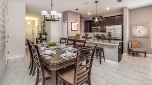 A modern kitchen with dark cabinets, stainless steel appliances, and a central island. - You Have Found the Perfect Holiday Villa on Storey Lake Resort With Every 5 Star Amenity, Orlando Villa 3664 (Kissimmee)