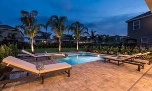 A swimming pool with lounge chairs and palm trees. - Ultimate 5 Star Villa With Private Pool on Encore Resort at Reunion, Orlando Villa 4363 (Kissimmee)