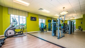 A gym with cardio machines, weight training equipment, and a large mirror. - You Will Love This 5 Star Villa Located on Storey Lake Resort, Orlando Villa 5492 (Kissimmee)