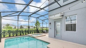 A pool area with a glass enclosure, a door, and a window with blinds. - You Will Love This 5 Star Villa Located on Storey Lake Resort, Orlando Villa 5492 (Kissimmee)