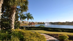 A landscaped area with a gazebo, a fountain, and a body of water. - You and Your Family Will Love This Townhome on Encantada Resort, Orlando Townhome 3663 (Kissimmee)