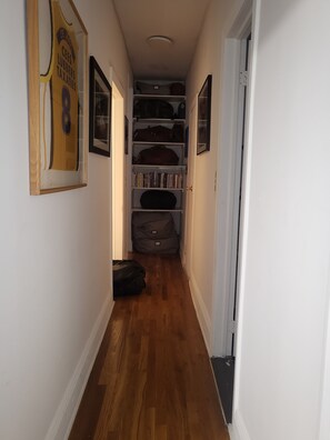 Stylish hallway with a framed picture and shelves lined with personal touches.