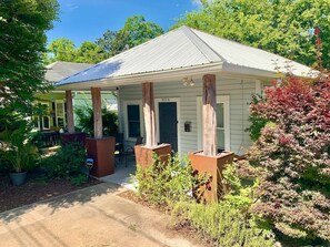 A small, single-story building with a covered porch, a front door, and a mailbox. - Lil' Bull Bungalow- walk to Duke, Downtown Durham & Food (Durham)